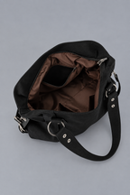 Intérieur vide du sac noir, doublure marron, sur fond gris