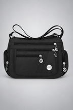 Sac noir multi-poches sur le fond gris clair studio